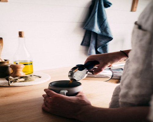 Person preparing morning coffee in a calm kitchen